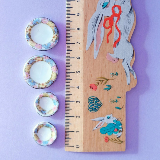 Neljän lautasen setti nukkekotiin.